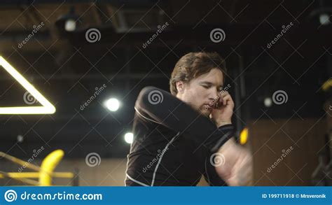 Strict Sport Man Warming Up Elbows In Fitness Center Boxer Exercising