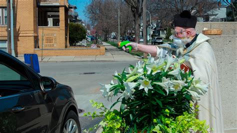 Detroit Priest Uses Squirt Gun Full Of Holy Water In Viral Photos