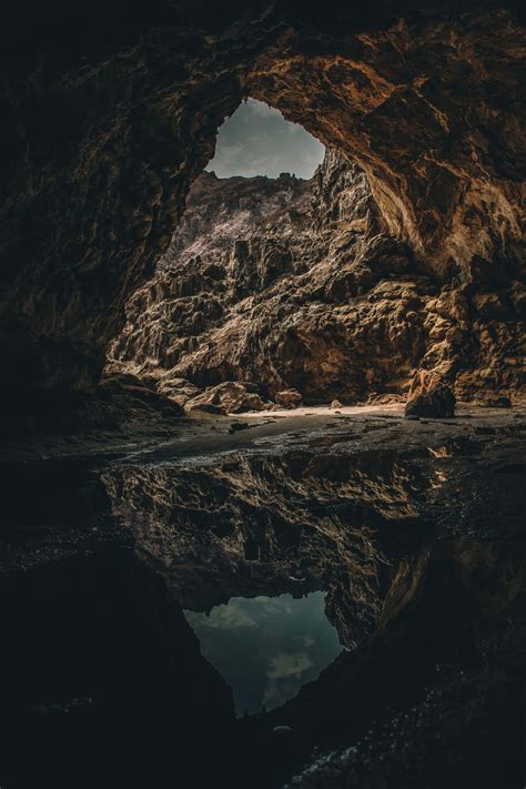 Download A Cave With A Reflection In The Water