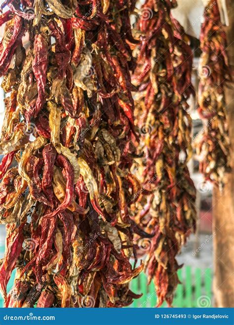 String Drying Red Chili Peppers Hanging On A Farmhouse Stock Image