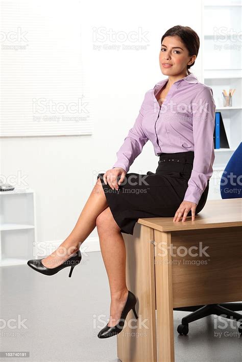 Relaxed Beautiful Young Business Woman Sitting On Office Desk Stock