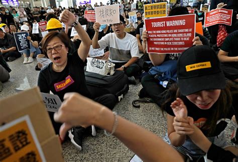 Hong Kong Protesters Take Their Cause To Airport Arrivals