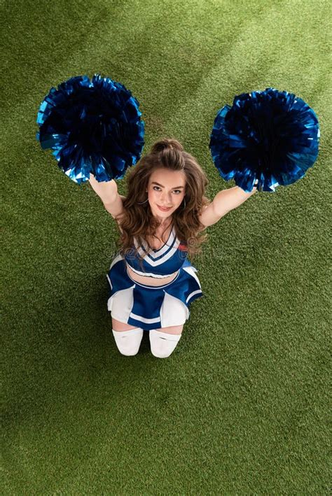 View Of Smiling Cheerleader Girl In Blue Uniform Sitting With Pompoms 20010 Hot Sex Picture