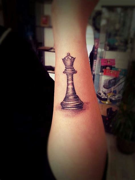 A Black And White Chess Piece Tattoo On The Arm