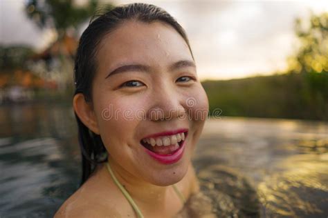 Young Beautiful And Happy Asian Chinese Woman In Bikini Enjoying Sunset Taking Selfie At Amazing