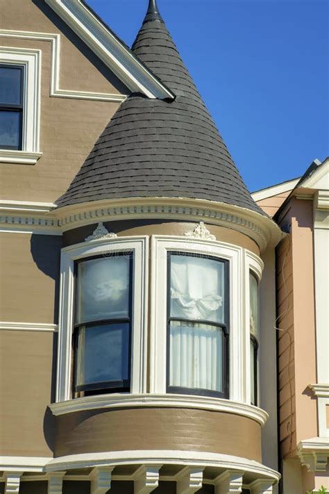 House With Spire Or Turret And Panoramic White Windows With Brown Roof