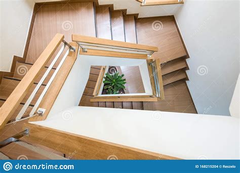 A Tricky Shape Curved Wooden Staircase Or Stairway From The Top Looking