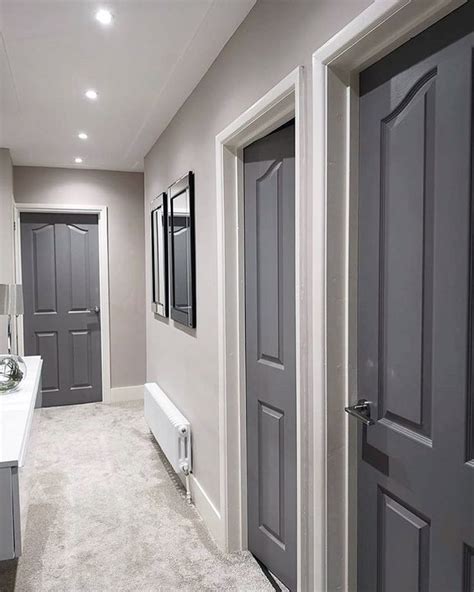 An Instagram Photo Of A Bathroom With Gray Doors And White Fixtures On