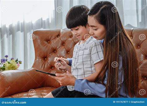 Asian Mother Work Home Together With Son Mom Teaching Kid For Online