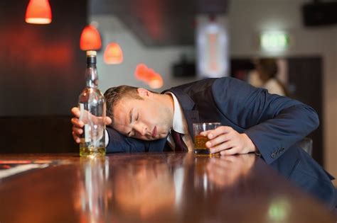 Premium Photo Unmoving Businessman Holding Whiskey Glass Lying On Counter