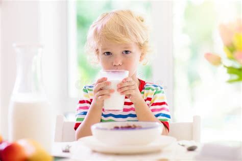 Child Eating Breakfast Kid With Milk And Cereal Stock Photo Image Of