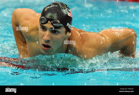 usa s michael phelps struggles out of the water after swimming the butterfly part of the men s