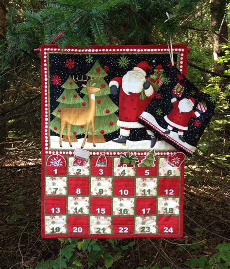 A Quilted Christmas Calendar Hanging From A Tree
