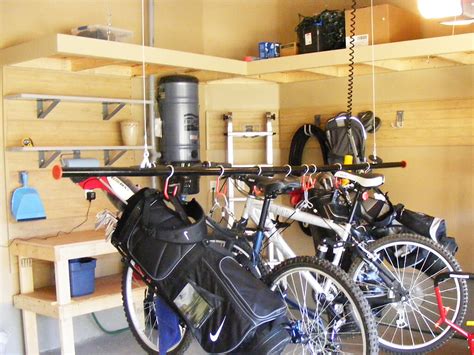 Bicycle hoisted and excess pulley rope attached to wall holder. Bicycle Storage & Bike Racks — Nuvo Garage