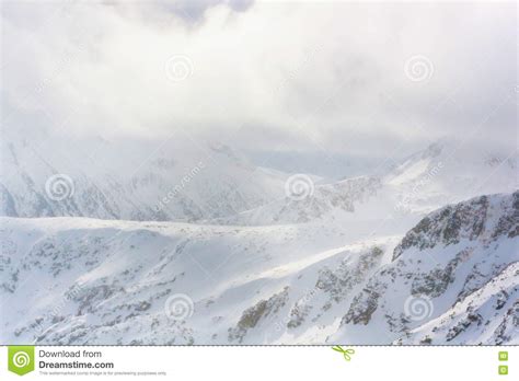 Panorama Of Snow Mountain Landscape With Fog And Clouds Stock Photo
