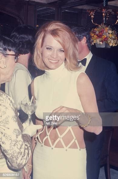 Angie Dickinson At A Formal Event Wearing A White Bare Midriff Dress