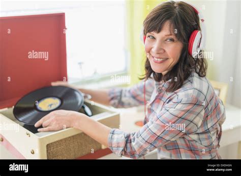 Woman Listening To Music On Antique Record Player Stock Photo Alamy