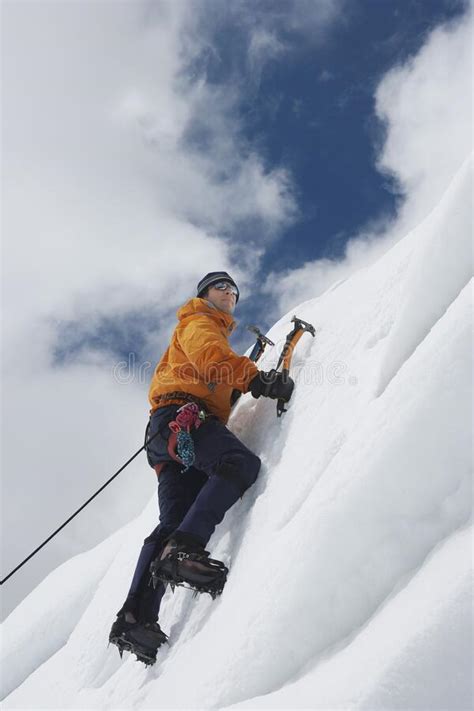 Mountain Climber Going Up Snowy Slope With Axes Stock Photo Image Of