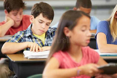 Pupils Studying At Desks In Classroom Stock Image Image Of Classroom