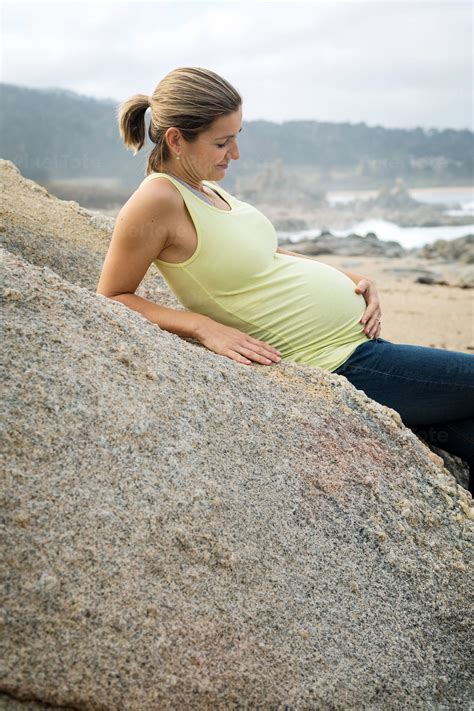 Smiling Pregnant Woman On A Beach Stock Photo Pixeltote