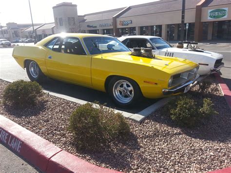 Two Cars Are Parked In The Parking Lot