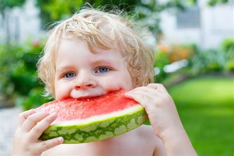 Little Toddler Boy Eating Healthy Watermelon In Summer Stock Photo
