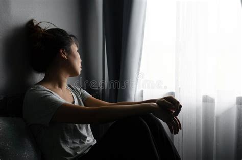 Stressed Young Asian Woman Suffering On Depression And Sitting Alone On