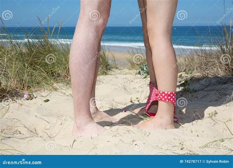 Couple Kissing On The Beach Closeup View Of Legs And Feet Stock Image