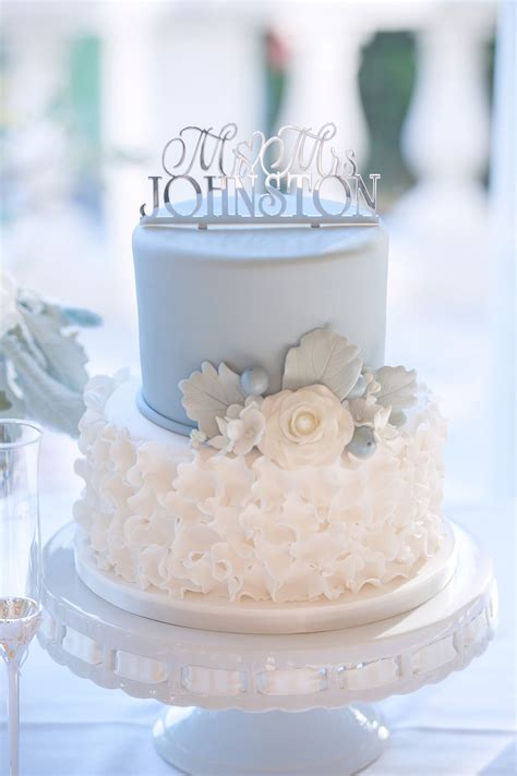 Create A Stunning White Wedding Cake With Blue Flowers