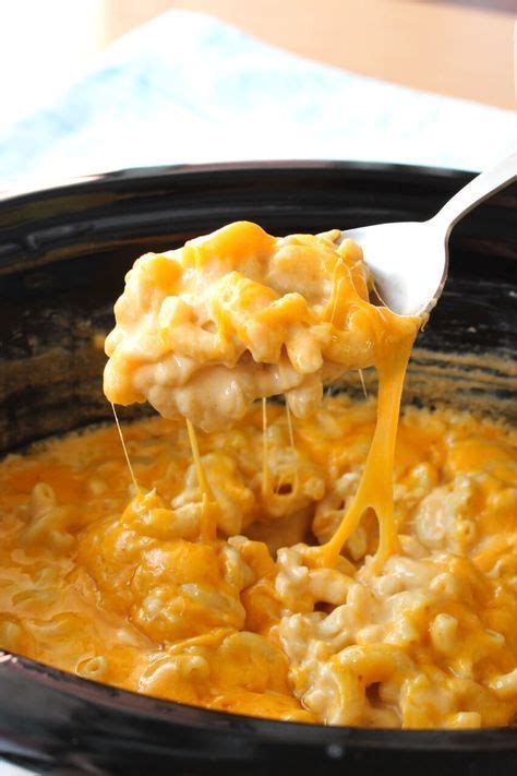 A Spoon Full Of Macaroni And Cheese Being Lifted From The Crock Pot