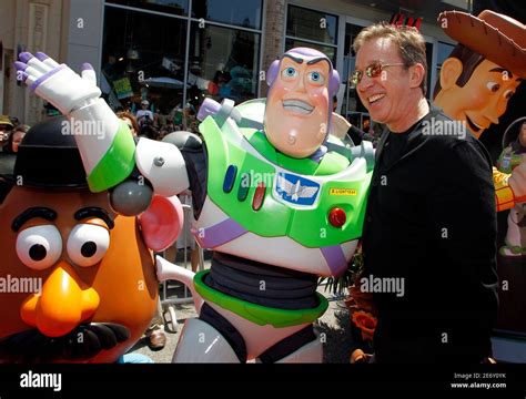 Actor Tim Allen Poses With The Character Buzz Lightyear L Whose