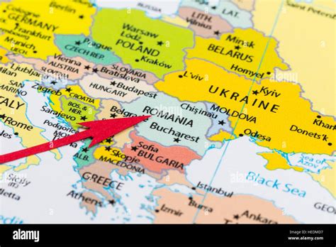 Red Arrow Pointing Romania On The Map Of Europe Continent Stock Photo