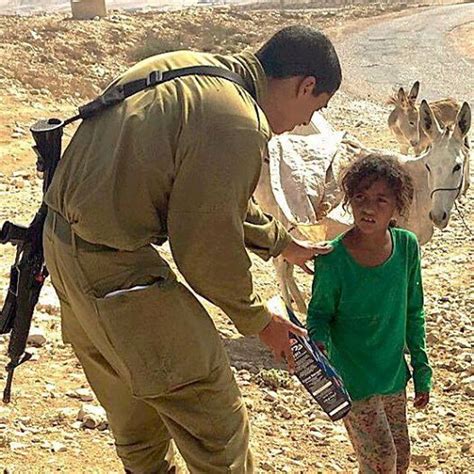 Image Of Israeli Soldier Giving Food To Arab Girl Rummaging Through Garbage Cans Goes Viral