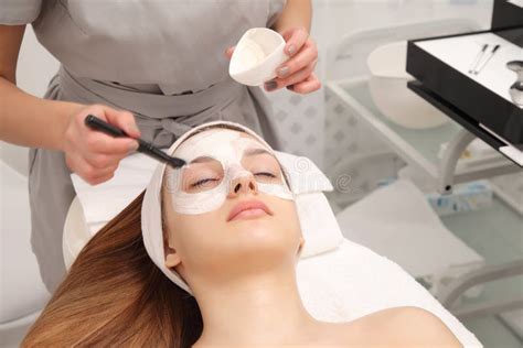 Facial Treatment Of Young Woman In A Cosmetology Salon Stock Photo