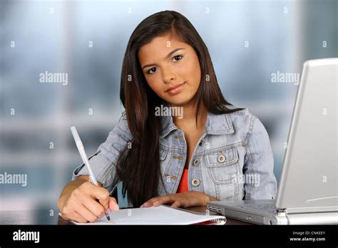 Girl Writing At Her Desk At School Stock Photo Alamy