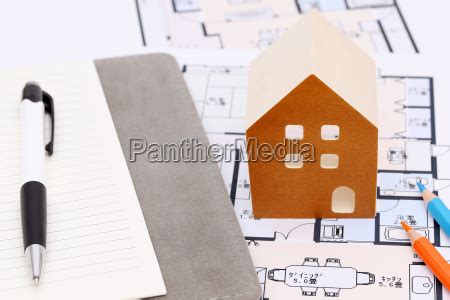 Miniature Model Of House On Blueprints Construction Stock Photo