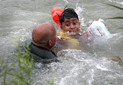 Dramatic Photos Show Migrant Boy Being Saved From Drowning By Border