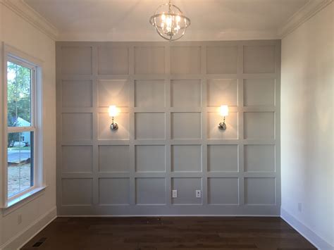 Chic art deco living room with low grey wainscoting to give volume to the walls. Grey feature wall with wall sconces | Accent walls in ...