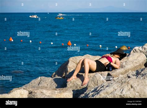 A Woman Sunbathes On Rocks Atrani Amalfi Coast Italy Stock Photo Alamy