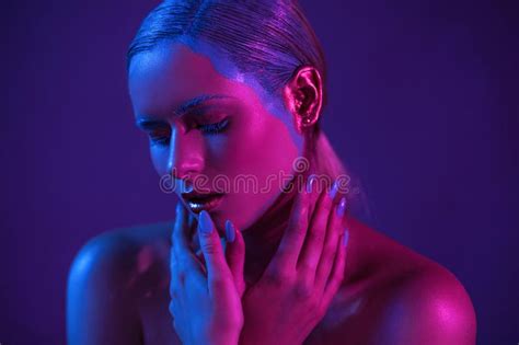 Stylish Girl Model In Neon Shade With Lowered Eyes Stock