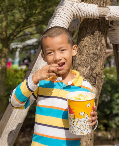 Asian Boy Eating Eating Popcorn Stock Image Colourbox