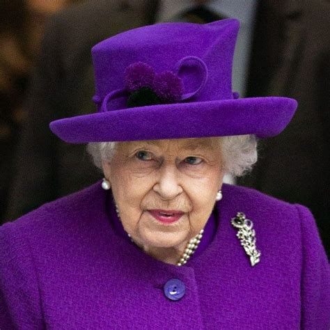 An Older Woman Wearing A Purple Hat And Coat With Pearls On Its Side
