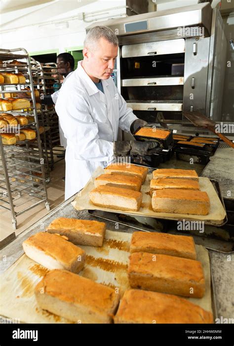 Bake Taking Out Bread From Baking Pans Stock Photo Alamy