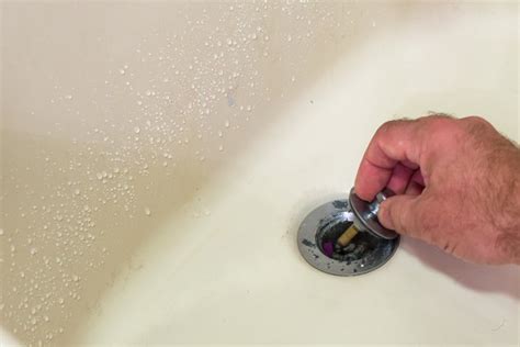 Flathead screwdriver, clean rag, pliers. How to Remove a Bathtub Stopper | Hunker