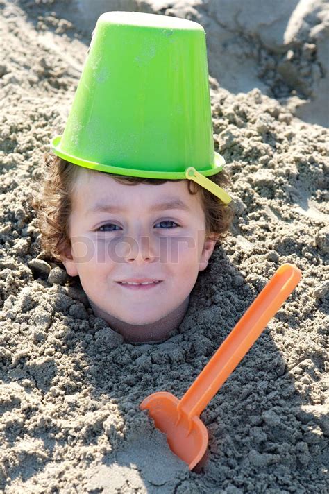 Child Buried In The Sand Stock Image Colourbox
