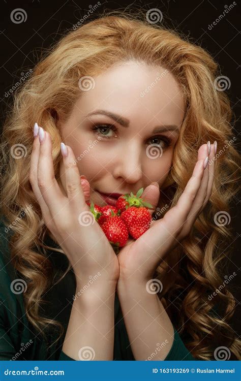 Beautiful Resilient Young Girl Holding A Strawberry Portrait In The