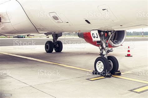 Landing Gear And Undercarriage Of A Jet Airplane Parked Stock Photo