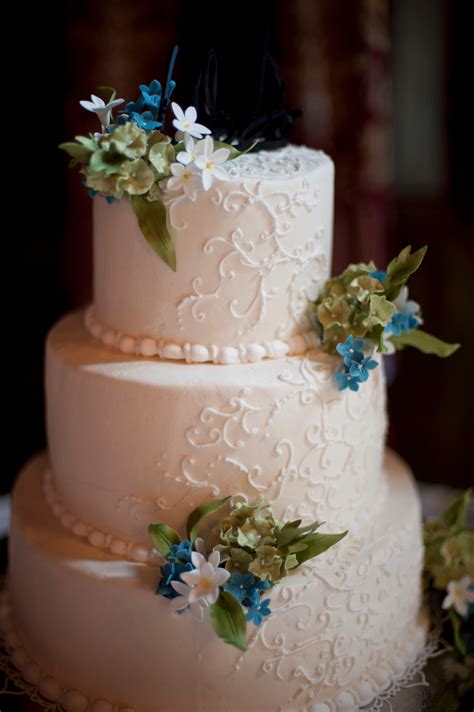 Get inspired to use real. Ivory Wedding Cake With Green, Blue and White Flowers