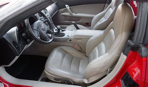 The Interior Of A Red Car With Leather Seats