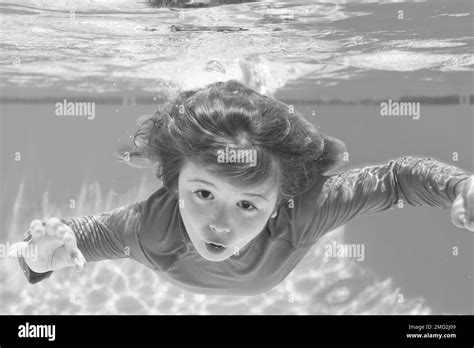 Boy Swim And Dive Underwater Under Water Portrait In Swim Pool Child